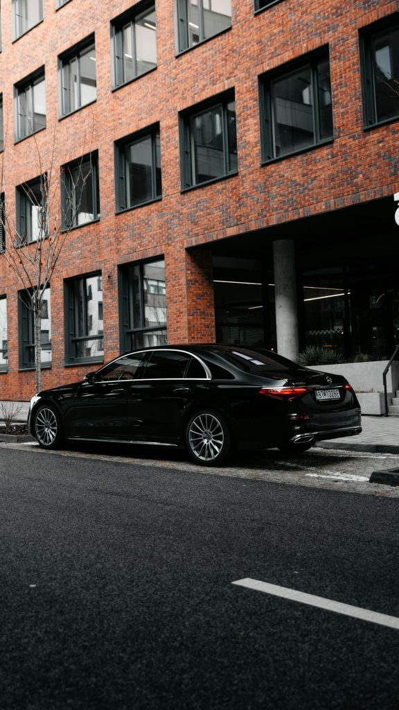 Mercedes S-Class executive saloon outside a brick building
