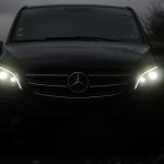 Black Mercedes V-Class MPV with headlights on